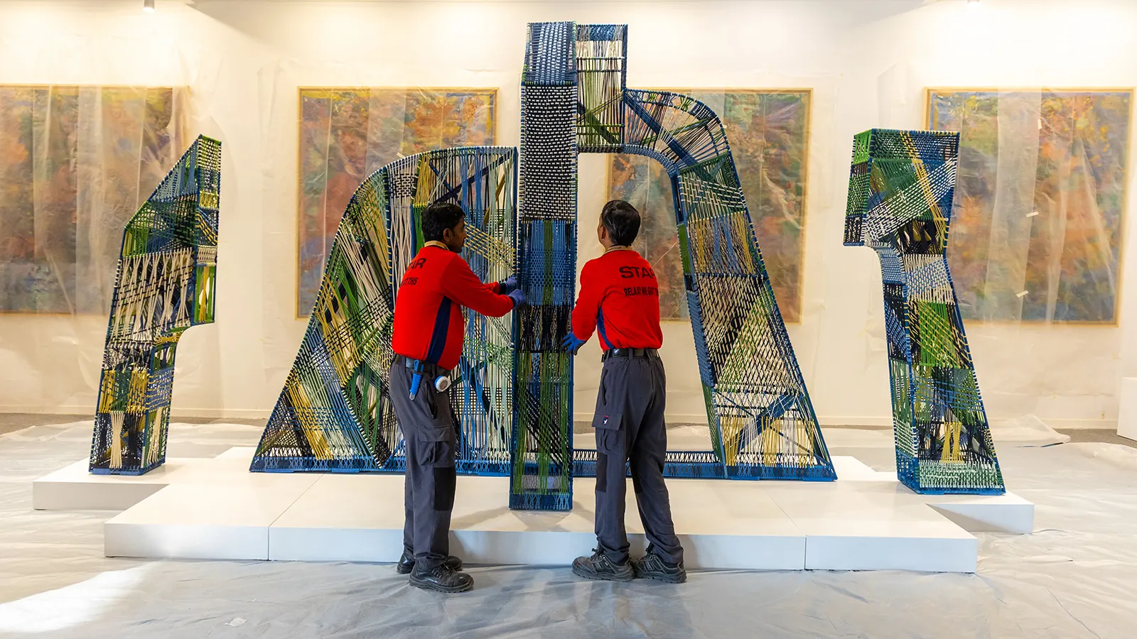 Star Worldwide Group art handlers wrapping artworks inside an exhibition hall