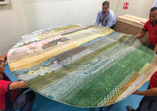 Star Worldwide Group team carefully handling and rolling an artwork for international shipment to Homo Faber 2026 exhibition in Venice